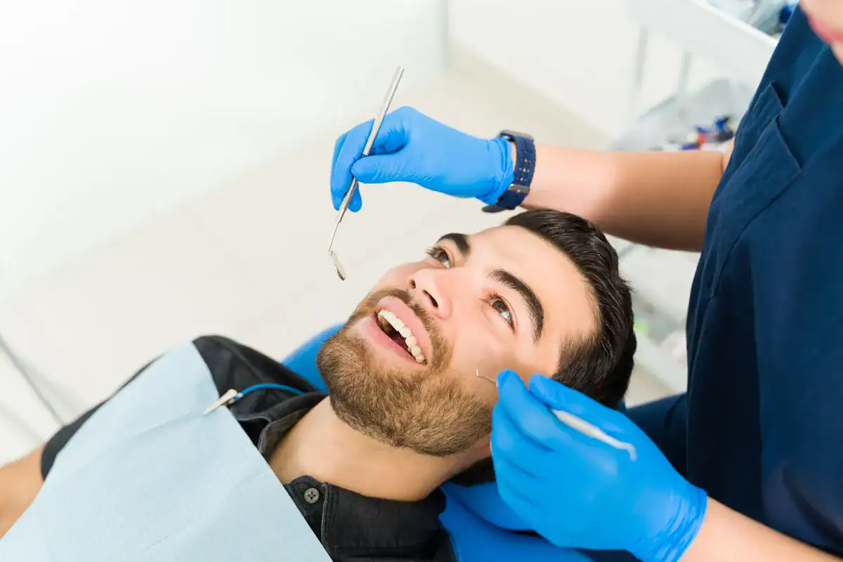 A smiling man receiving dental treatment