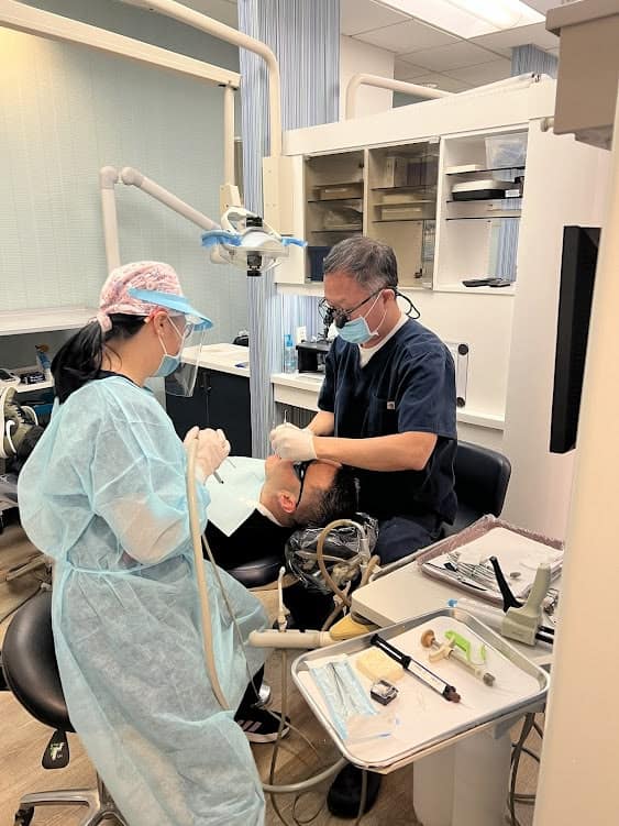 Dr Byun performing a procedure on a patient in a clinical setting.
